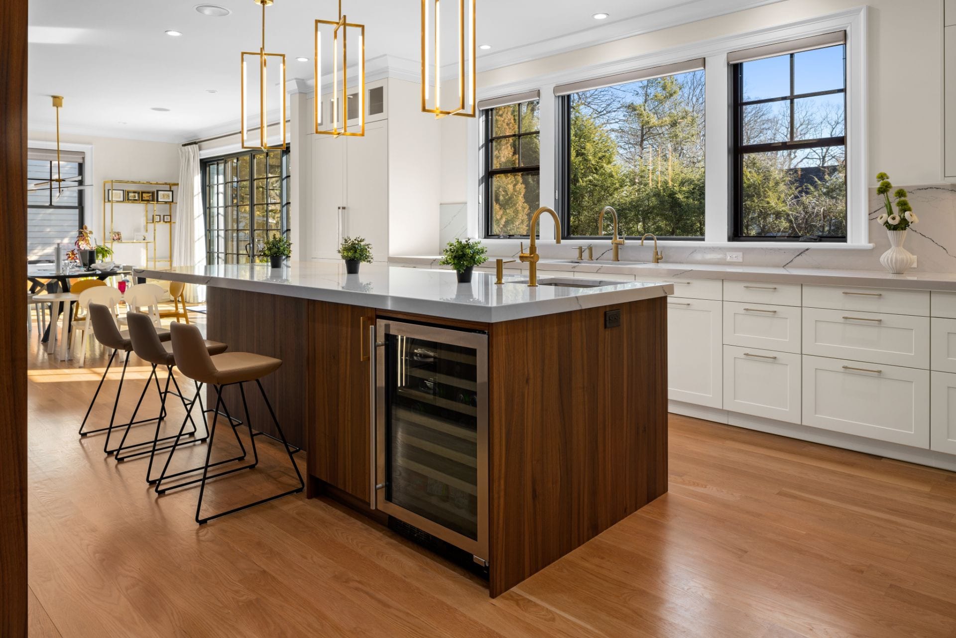 White and walnut kitchen with brass pendants