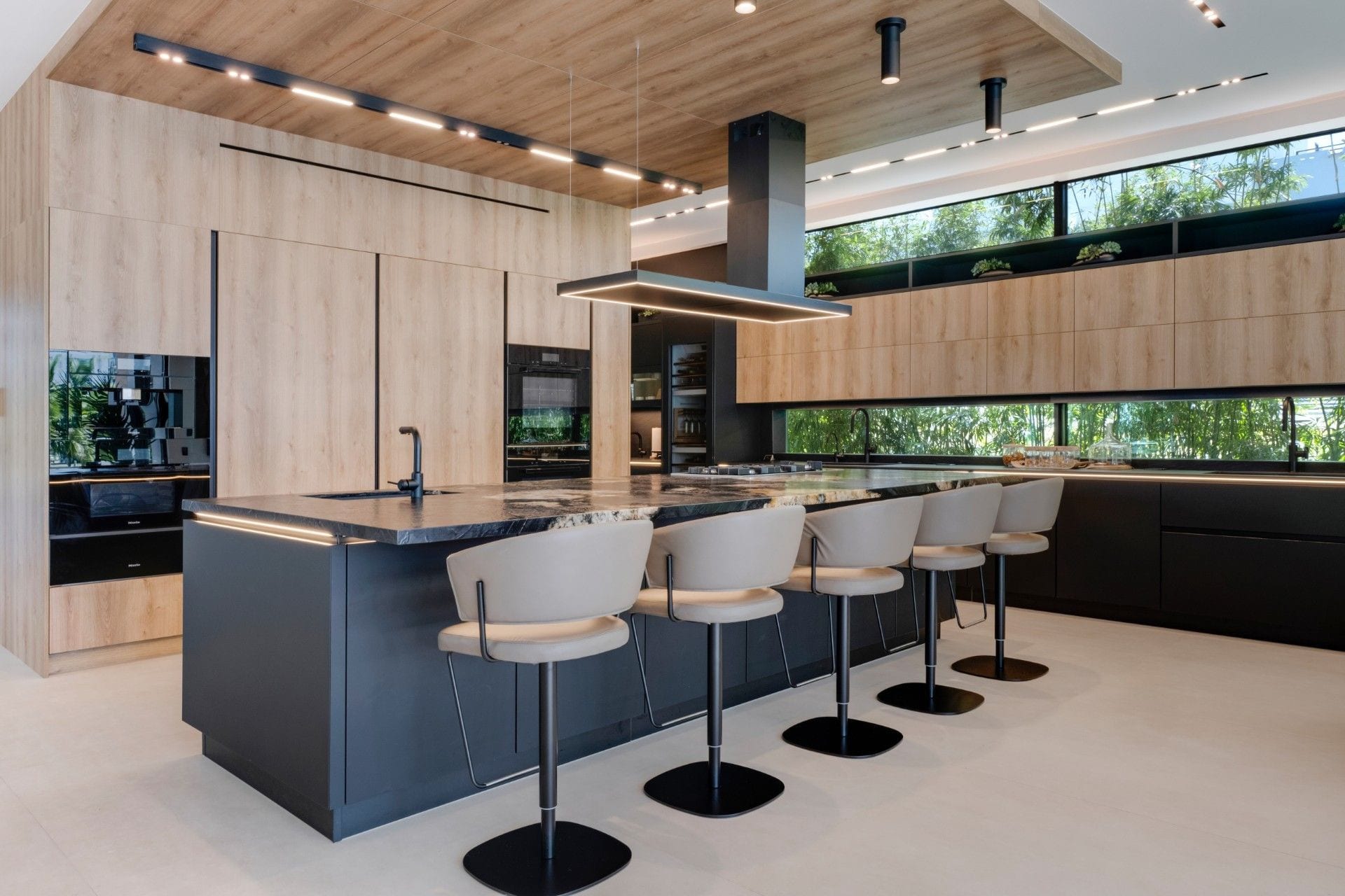 Oak and black slate kitchen with a long island, Miami
