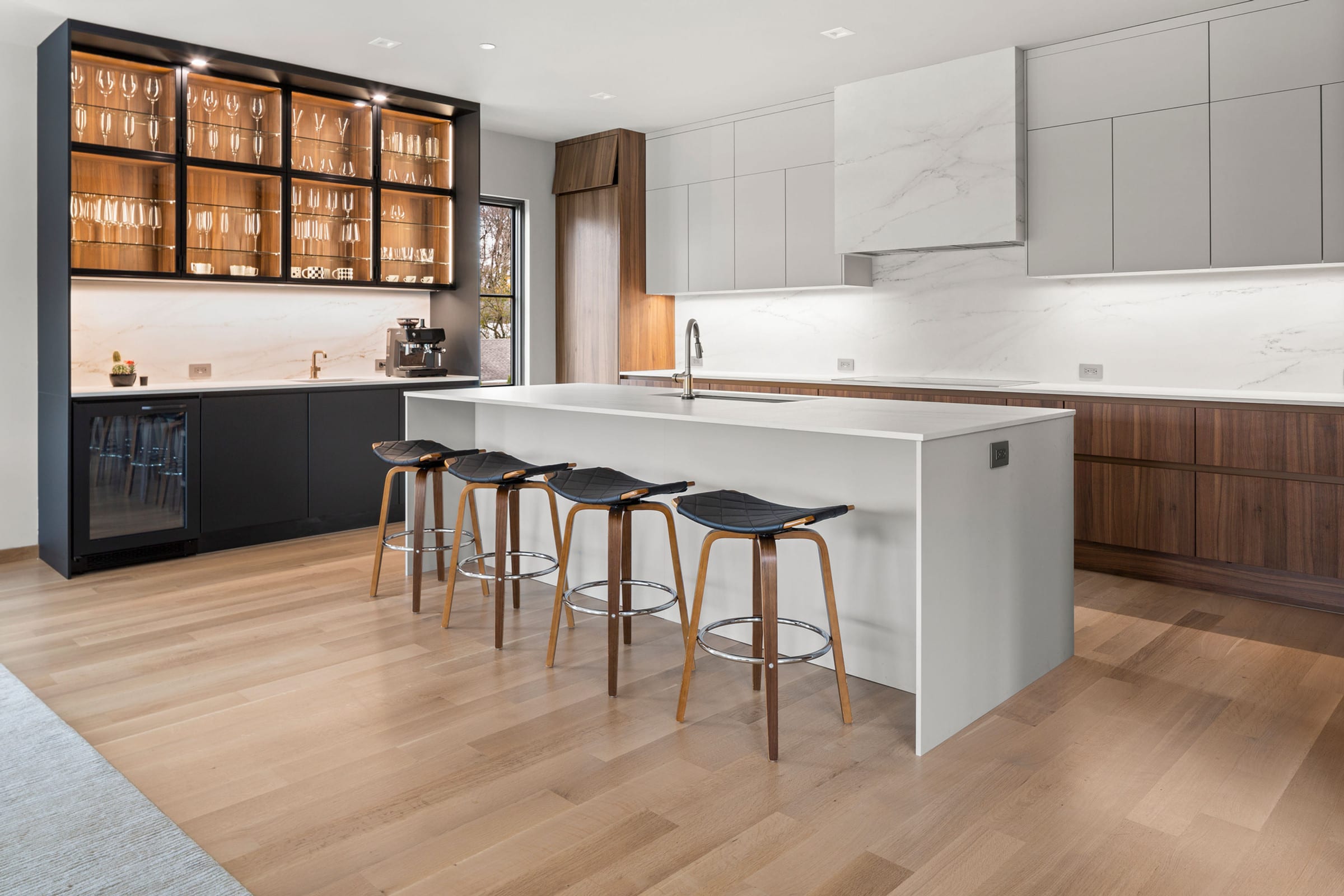 Walnut and white kitchen with marble island and black glass bar, Eastchester NY