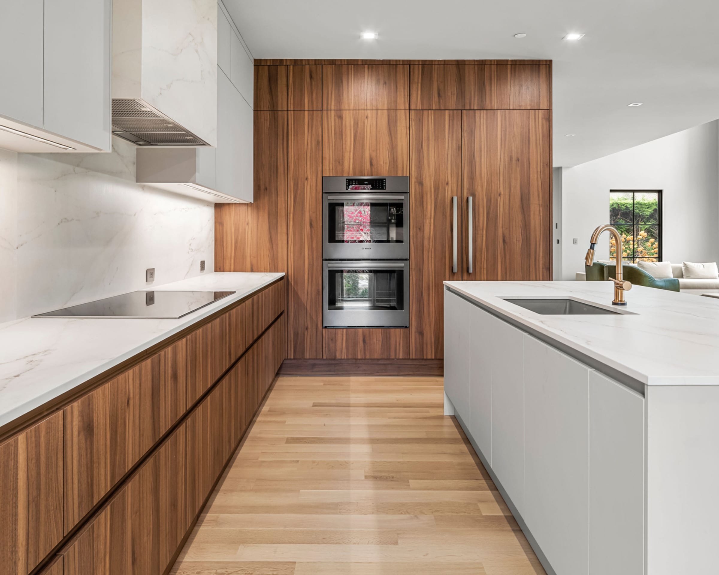 Tall walnut wall with double ovens