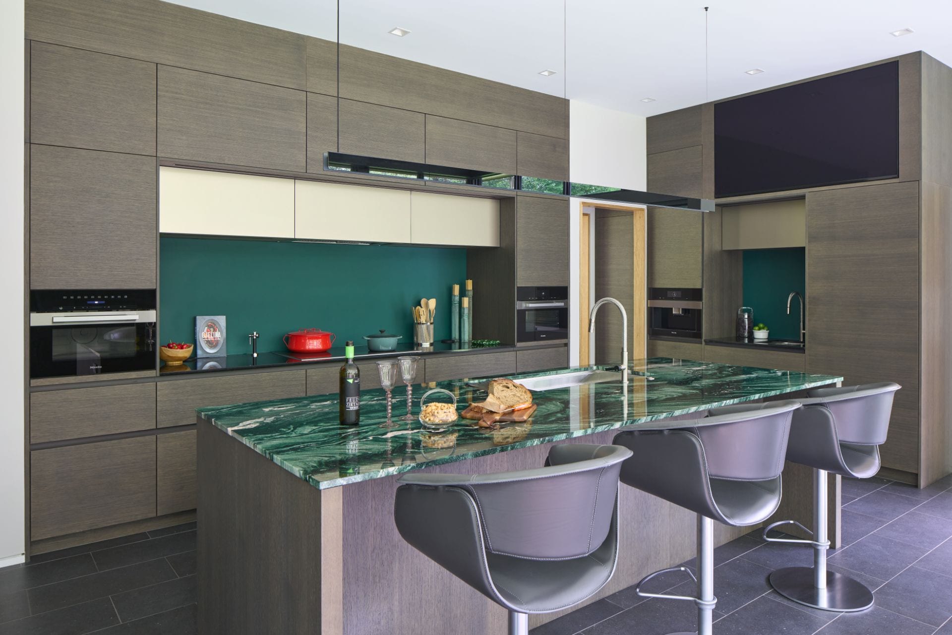 Oak and bronze kitchen with green stone counter