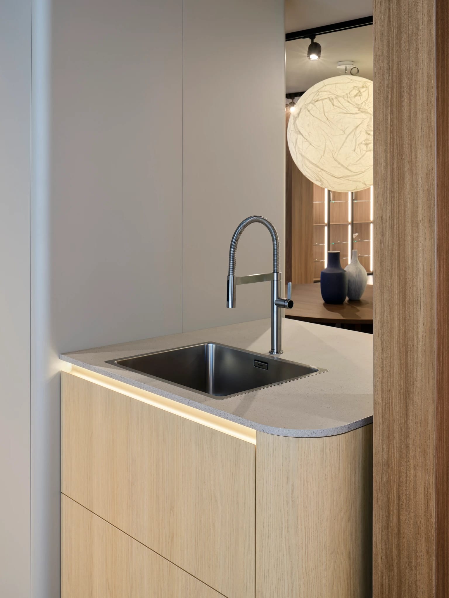 Rounded oak sink run with a lit curved edge