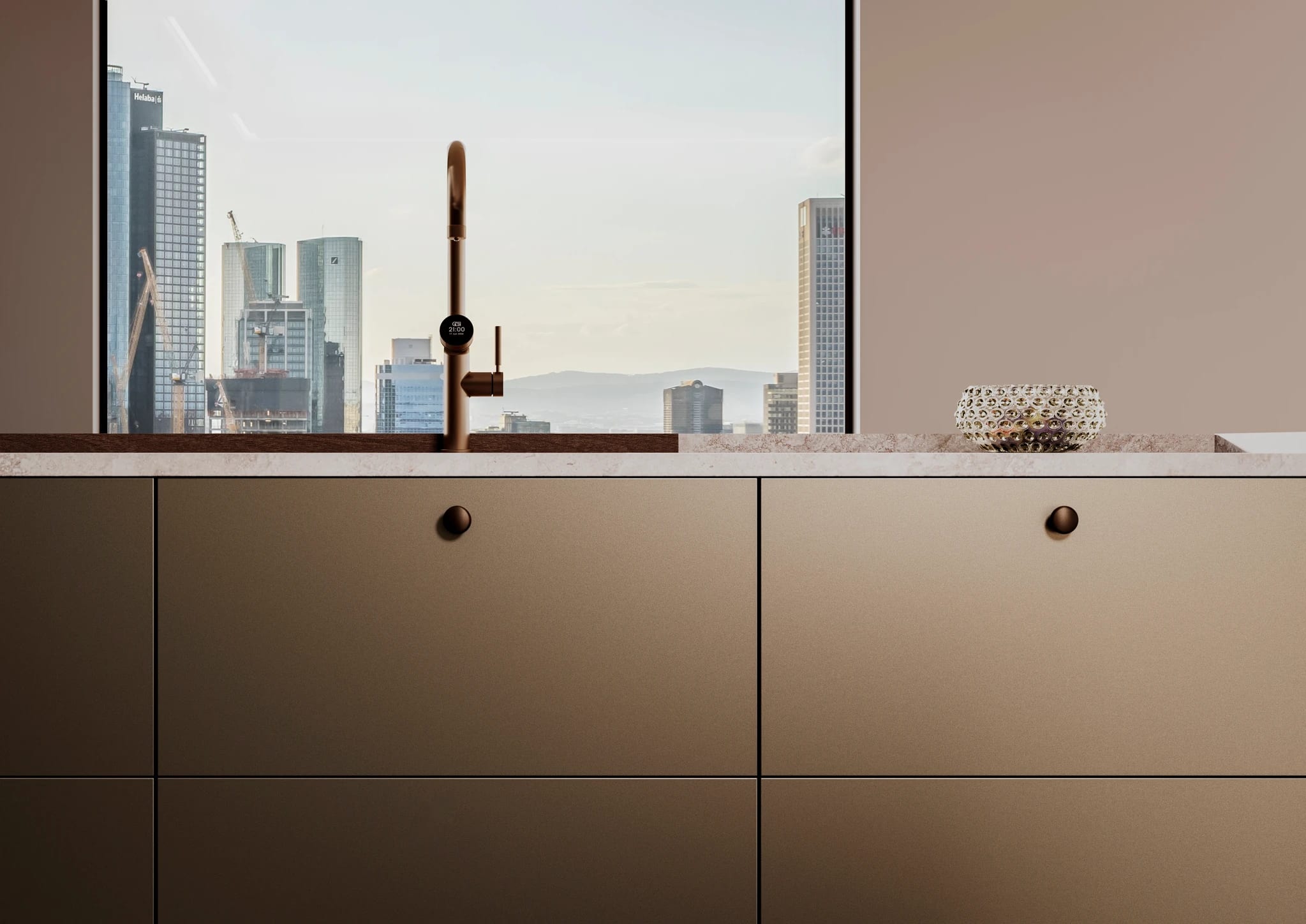 Bronze base cabinets beneath a skyline window